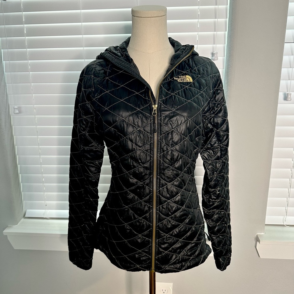 The North Face black with gold stitching quilted thermoball with hood